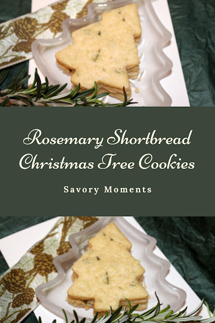 Baked rosemary shortbread Christmas tree shaped cookies sitting on a tree shaped plate with rosemary and a pinecone ribbon.