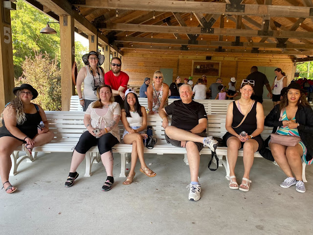 Group sitting outside under a pavilion. Credit: Jenny Huynh.