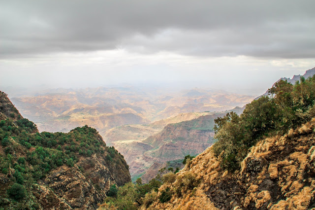 view of the surrounding canyons and mountains from our hike in the simien mountains on a foggy day