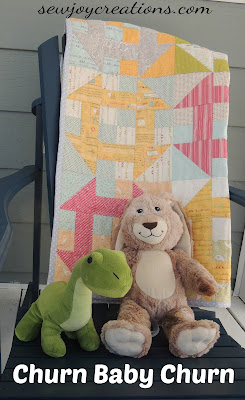 quilt on chair outside with stuffies