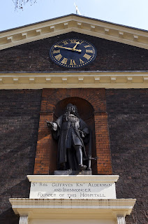 Founder's statue in alcove high in the building under the clock