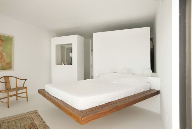 Floating wooden bed in the bedroom 