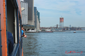  The ferry returns to the Lower Manhattan terminal providing a view of the Brooklyn Bridge and the east river from the port side of the boat. Travel photography by Kent Johnson.