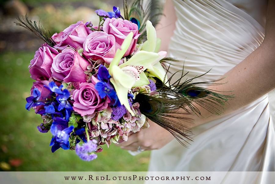 The peacock feathers add to the striking aesthetic while the pale pink 