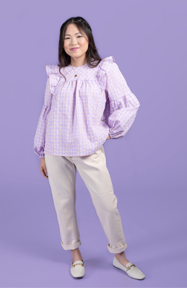 Model wearing a lilac and pink gingham blouse, made using the Marnie sewing pattern in cotton.