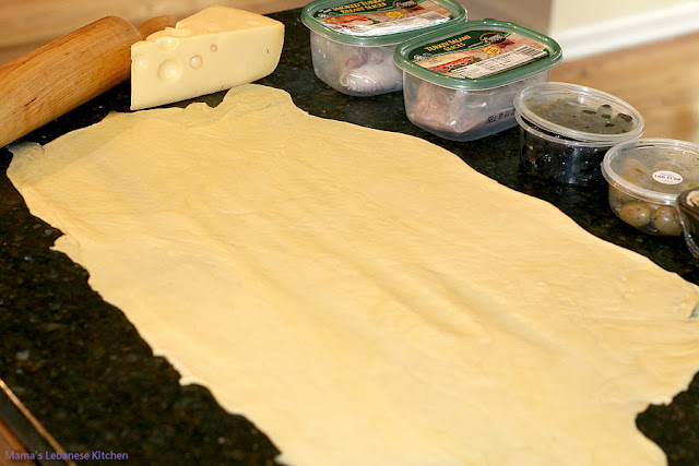 Roll dough on four-dusted kitchen counter