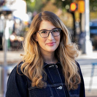 photo of a young woman with glasses.