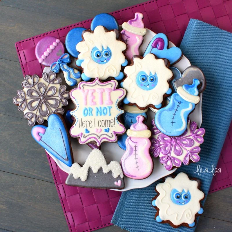 Yeti baby shower decorated chocolate sugar cookies in purple and blue