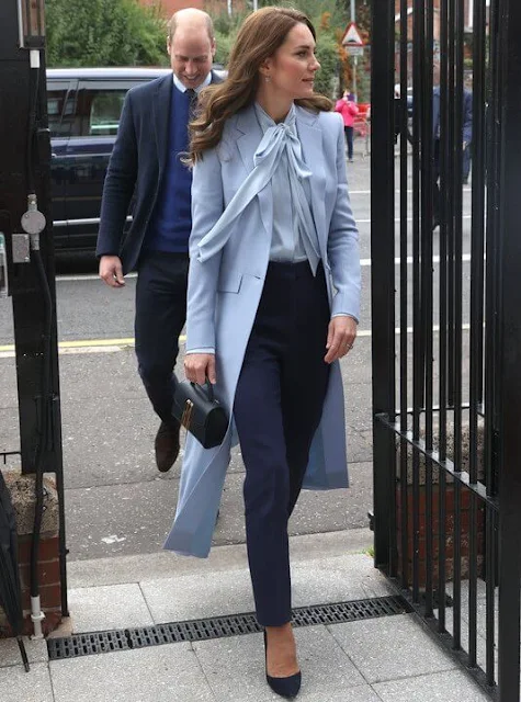 Princess Catherine wore a new soft blue bow silk blouse by Winser London. Gianvito Rossi navy suede pumps. Missoma Jewellery