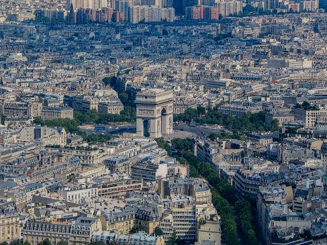 Arial view of Paris with the Arc de Triomphe central.