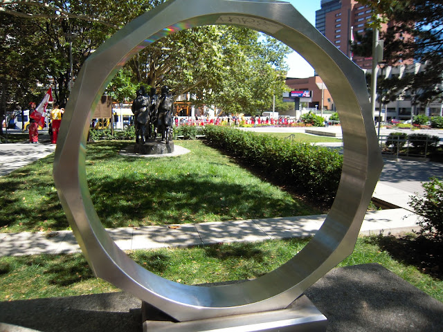 Peering through an giant iron ring, you can see the redsuits and first year students preparing to pull a city bus.