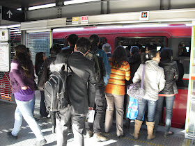 Passengers getting ready to board a pretty crowded Transmilenio