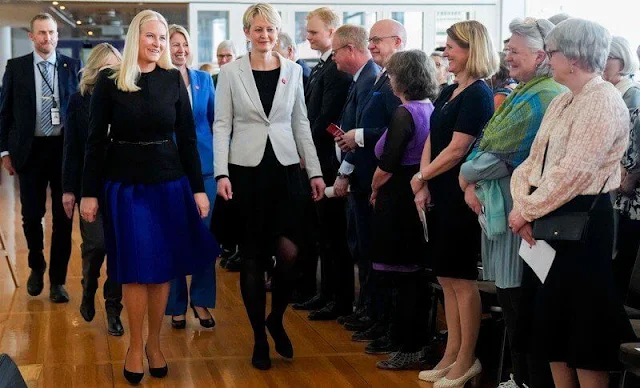 Crown Princess Mette-Marit wore a black jacket and a blue pleated skirt. Kristina Hermann Haugaa and Professor Ingvild Tina Saltvedt