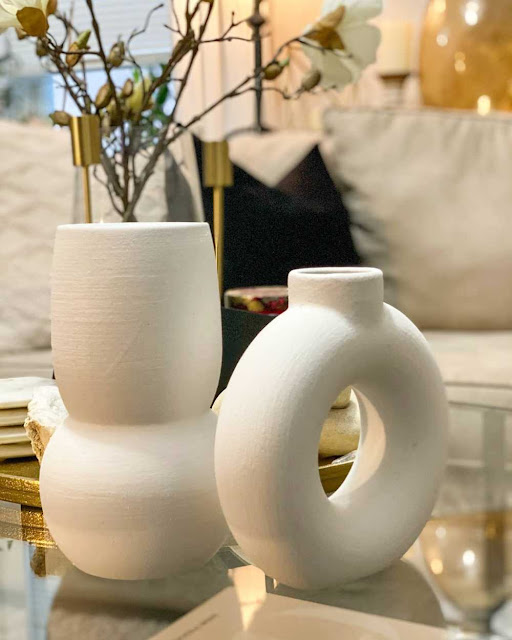 set of white modern vases on coffee table