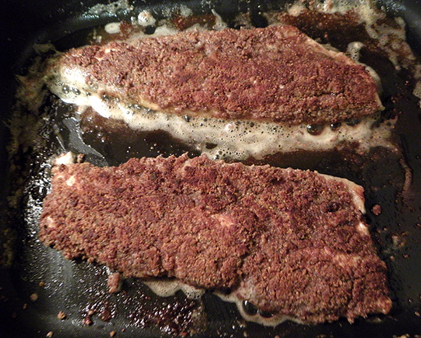 Two phat fillets frying in butter and oil