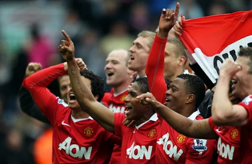 Manchester United players celebrate after winning the Premier League title