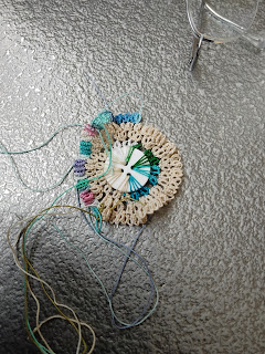 Tatting around a 4-hole button