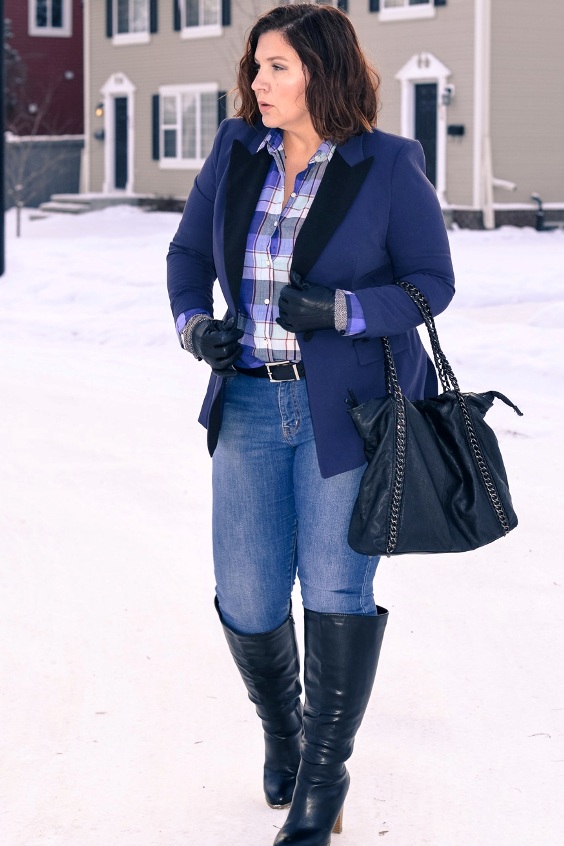 Pretty curvy  lady wearing a blue blazer,  jeans and black knee-high boots