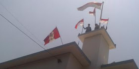 orang indonesia merobek bendera belanda di atas gedung 