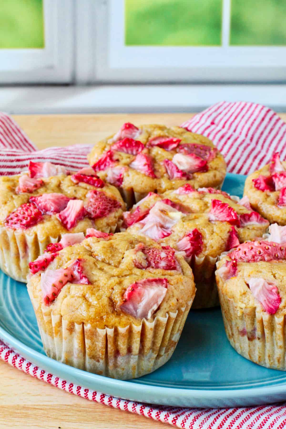 Orange and Strawberry Whole Wheat Muffins on a blue plate.