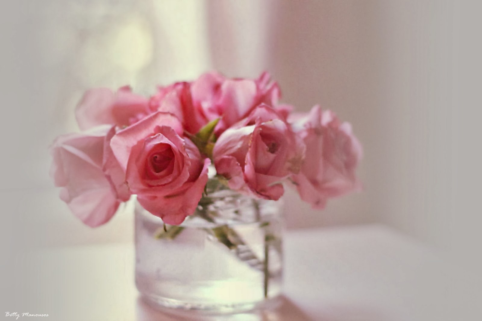pink roses in a crystal vase