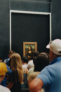 Photo by Simon Ly of people in front of the Mona Lisa painting