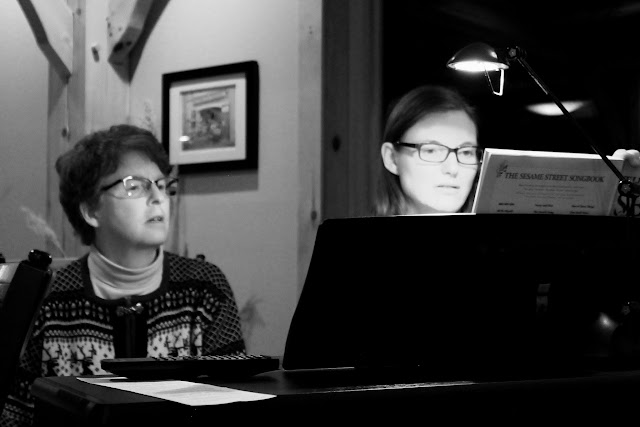 Martha accompanies Andrea McCrady at a choir Christmas party