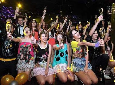 Raise your glasses: The performers and dancers toasting the guests to mark the opening of the club at Bukit Bintang.