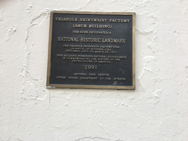 Plaque with text reading Triangle Shirtwaist Factory (Asch Building) has been designated a National Historic Landmark. The Triangle Shirtwaist Factory Fire, in which 146 workers died, occurred here on March 25, 1911. This building possesses national significance in commemorating the history of the United States of America. 1991. National Park Service United States Department of the Interior.