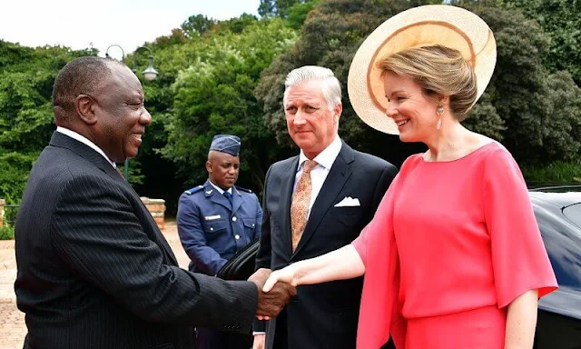 Queen Mathilde wore a fuchsia pink cape silk dress by Natan. President Cyril Ramaphosa and Minister Lindiwe Zulu