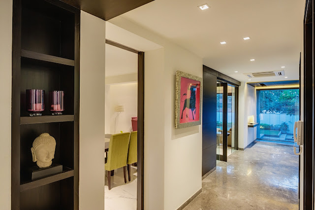 Picture of the hallway with dark brown shelves and white walls