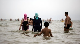 Women wearing masks on the beach