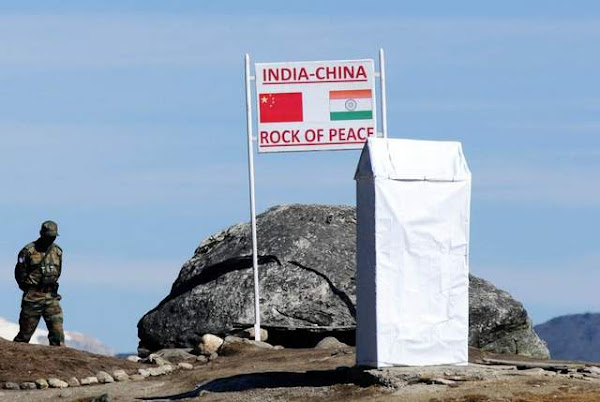 Indian soldiers keep watch at Bumla pass at the India-China border. India plans to develop a mountain corps to boost its presence in the area. (Agence France-Presse)