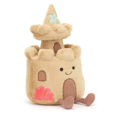 This is Jellycat Amuseable Sandcastle coming with soft sandy-brown fur, two-tiers, dark brown suede door and windows, with embroidered coral pink shells and turquoise starfish. Finished with a cute stitched, smiley face.