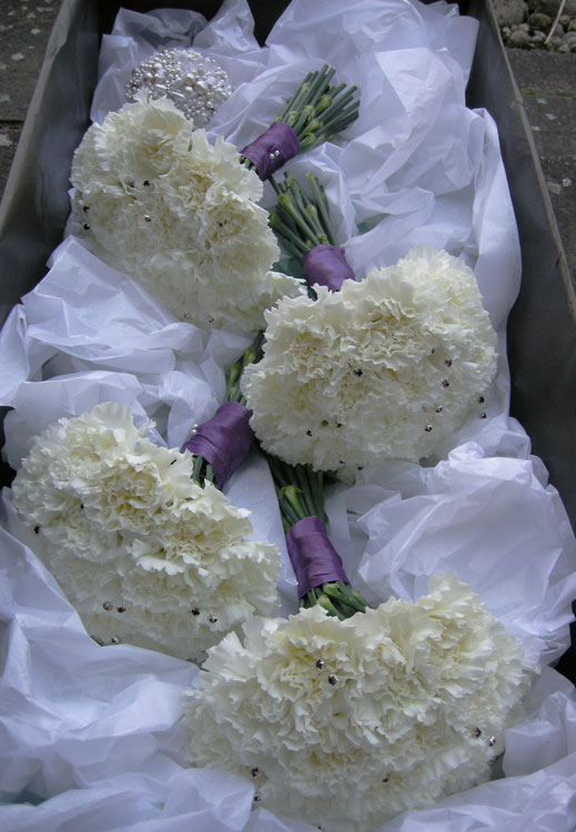 Ivory and purple bridesmaid's bouquet of massed carnations the detail shot