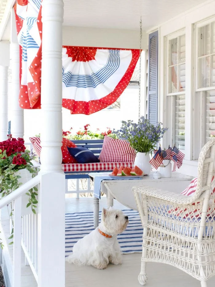 white cottage porch, gingham, bunting, red flowers