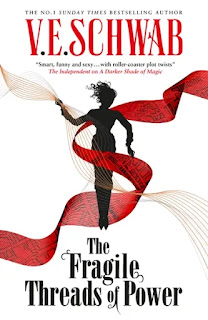 Cover for book "The Fragile Threads of Power" by VE Schwab. A silhouetted figure in black with curly hair is surrounded by streamers of red and while, the red streamer overlaid with a street map.