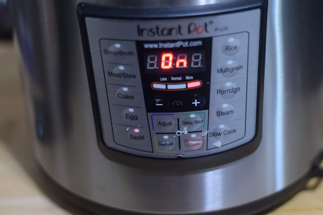 The instant pot set to saute to allow the sauce to thicken. 