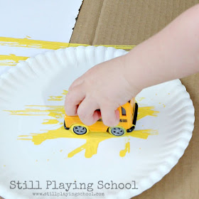 Painting with a toy bus for back to school