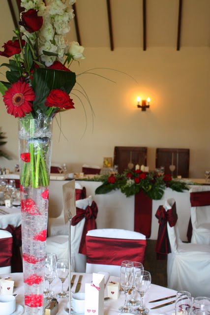  with a hand tie of Delphiniums Burgundy Roses and Burgundy Gerbera