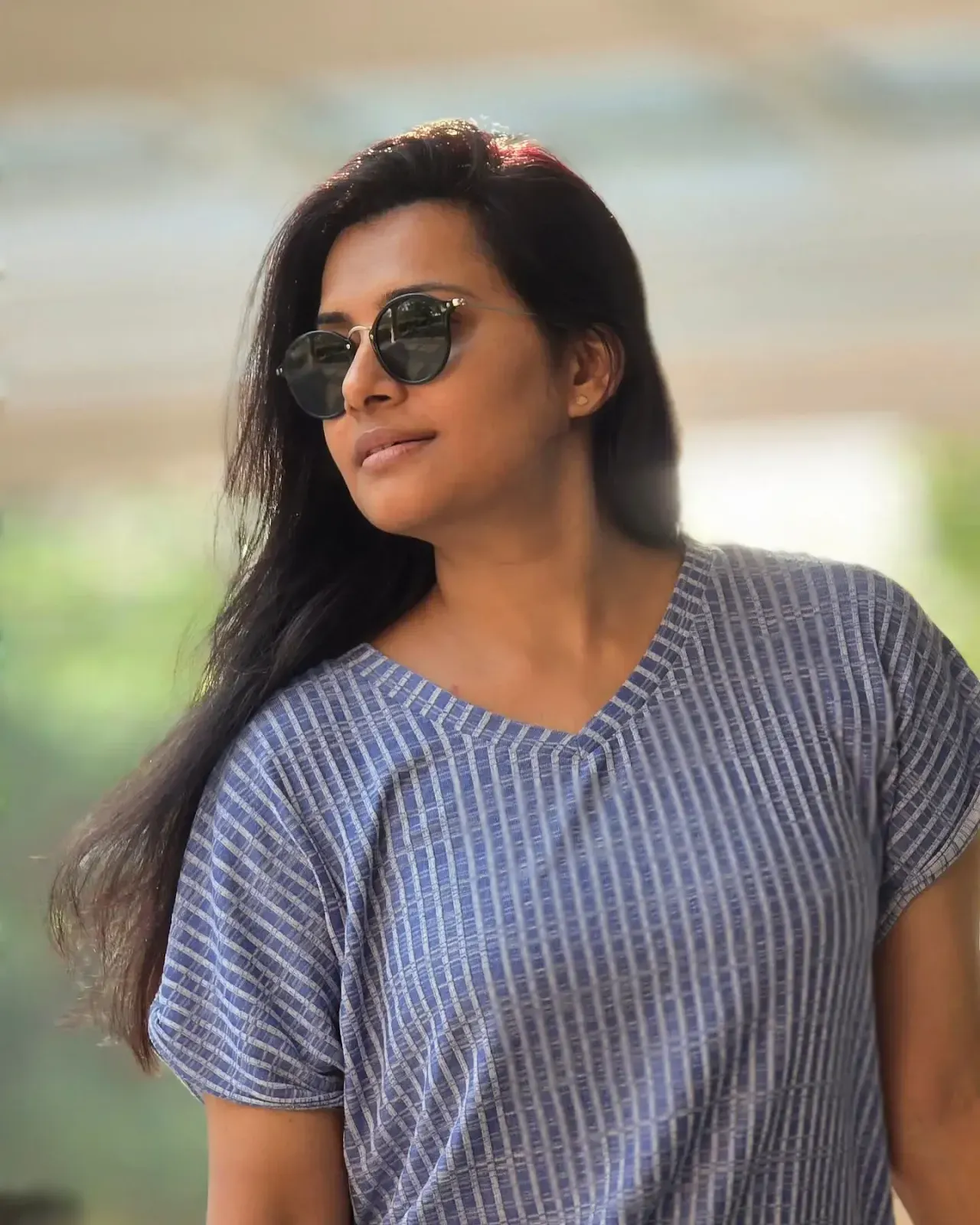 Sruthi Raj showcases a chic modern look in a white crop top and ripped jeans, radiating youthful charm.