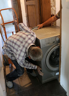 Pushing the washing machine into the room