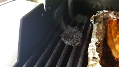 Wood chip puck almost used up, smoldering on the BBQ.