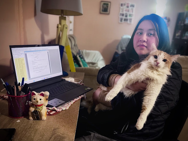 Elizabeth H. Vu and her cat Yoda during the writing process