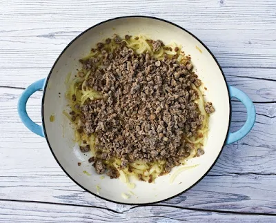 onions and veggie mince in white cast iron casserole pan