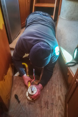 Photo of Phil removing the broken bilge pump