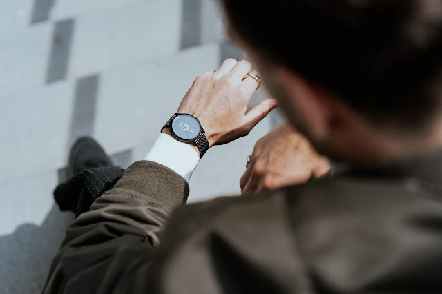 man checking time on watch - image via Unsplash.com