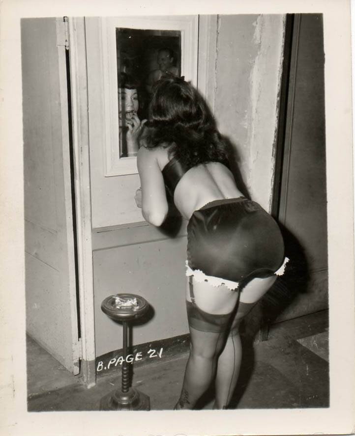 Bettie Page Checks Her Lipstick