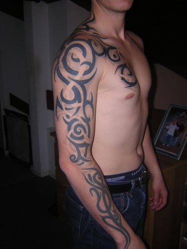 tribal tattoos chest to arm. tribal dragon tattoos arm