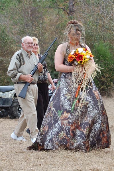 And the bride has a camo wedding dress on complete with camo veil